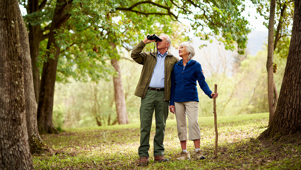 Senior Couple Bird Watching In Nature